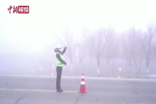 新疆：能见度30米 女交警雾中指挥