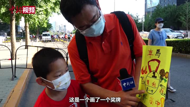 北京中考開考：家長穿紅衣討彩頭 送考萌娃自制“加油牌”