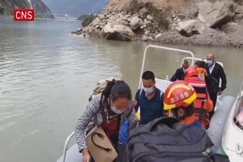 Rescuers take assault boats to transfer trapped villagers