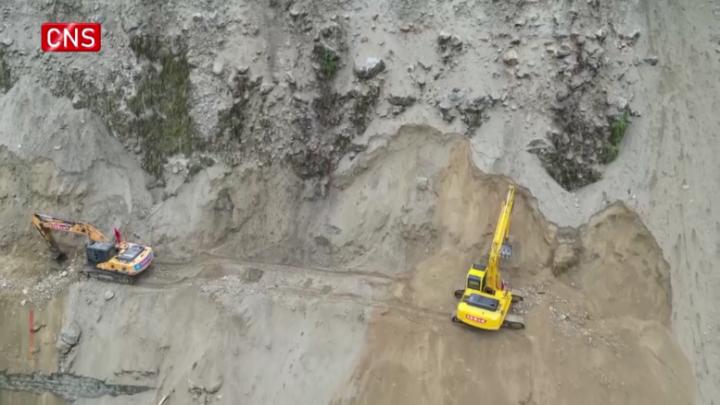 Excavators operate on huge landslide in quake-hit area in