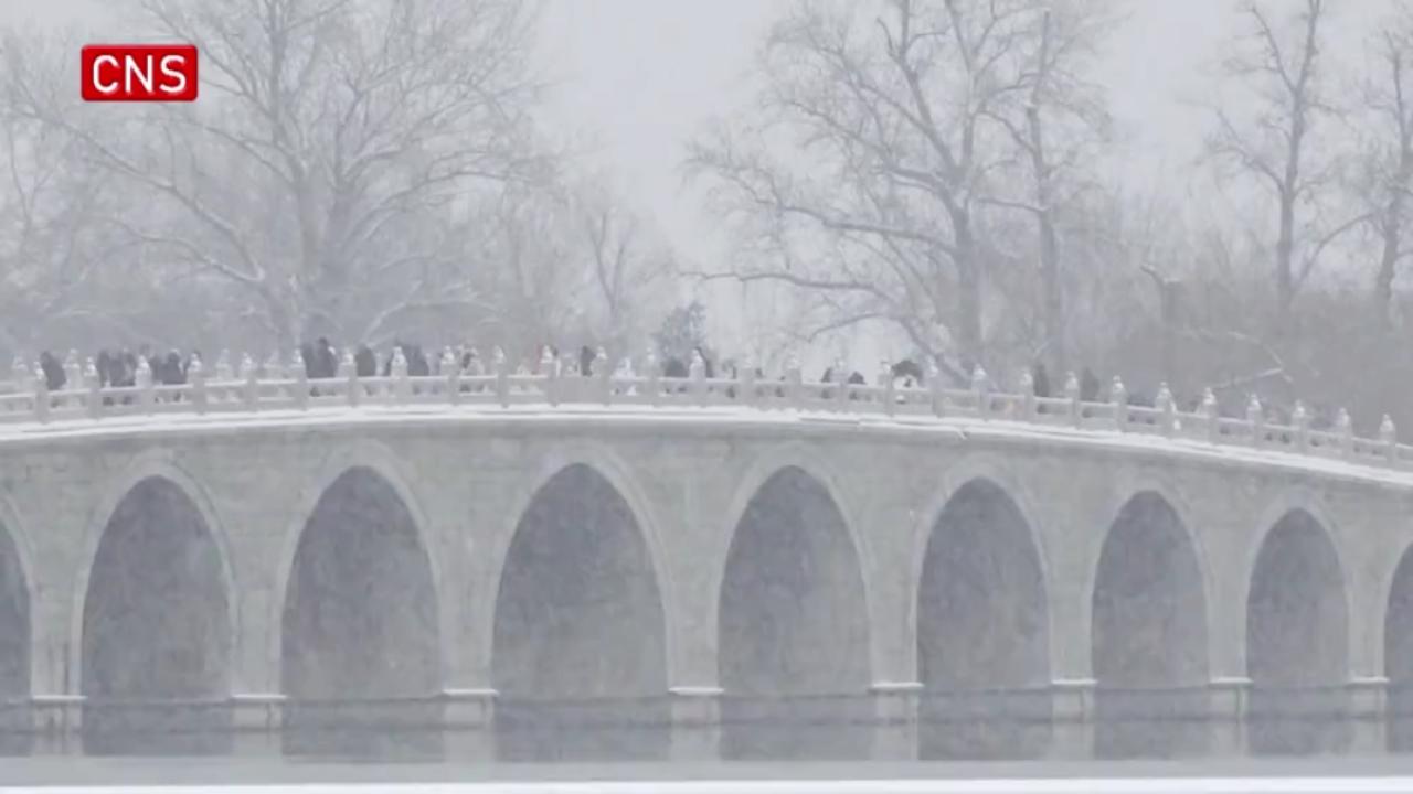 Tourists dressed in Hanfu enjoy snow at Beijing Summer Palace