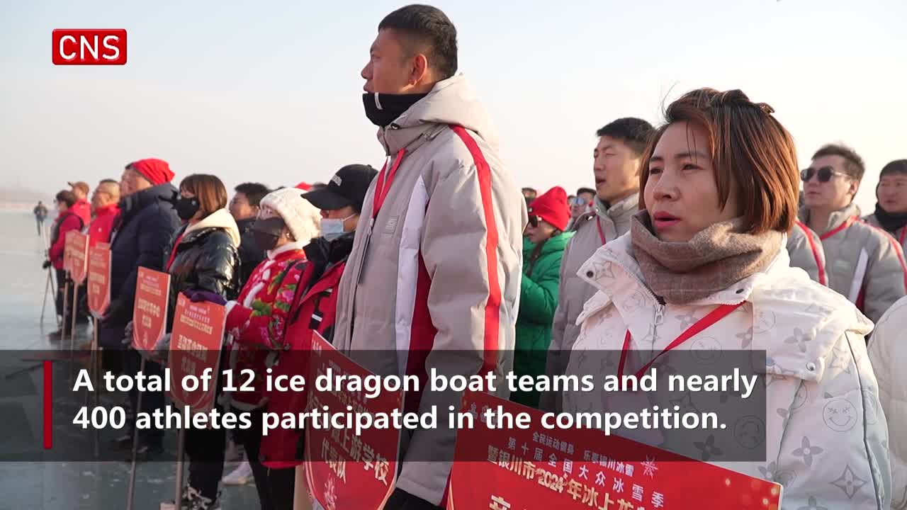 Competitors wearing distinctive team uniforms attend ice dragon boat race in NW China